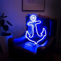 Blue neon anchor light on leather chair in dark room